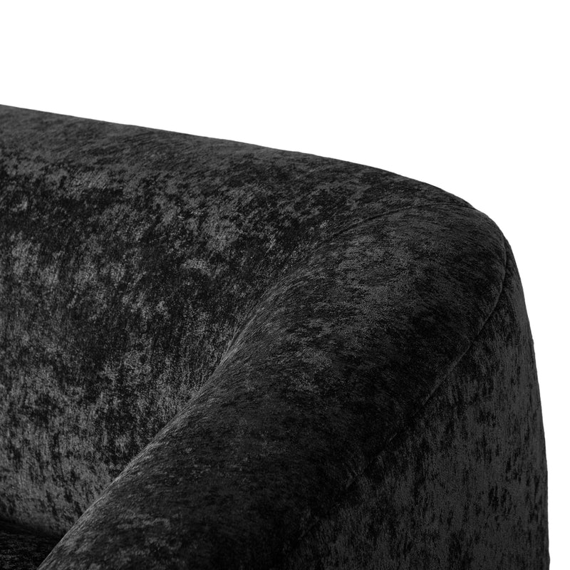 Left facing close up view of the backrest and arm on a contemporary black chenille sloping tuxedo loveseat on a white background