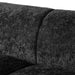 Left facing close up view of the backrest on a contemporary black chenille sloping tuxedo accent sofa on a white background