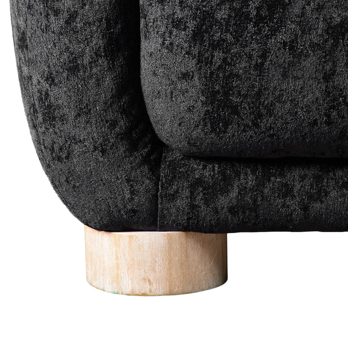 Front facing close up view of the leg on a contemporary black chenille sloping tuxedo accent sofa on a white background