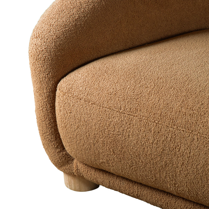 Left facing close up view of the inner armrest on a contemporary brown chenille sloping tuxedo accent armchair on a white background