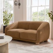 Left facing contemporary brown chenille sloping tuxedo loveseat in a room with accessories