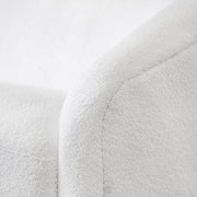 Left facing close up view of the upholstery and armrest on a contemporary white chenille sloping tuxedo loveseat