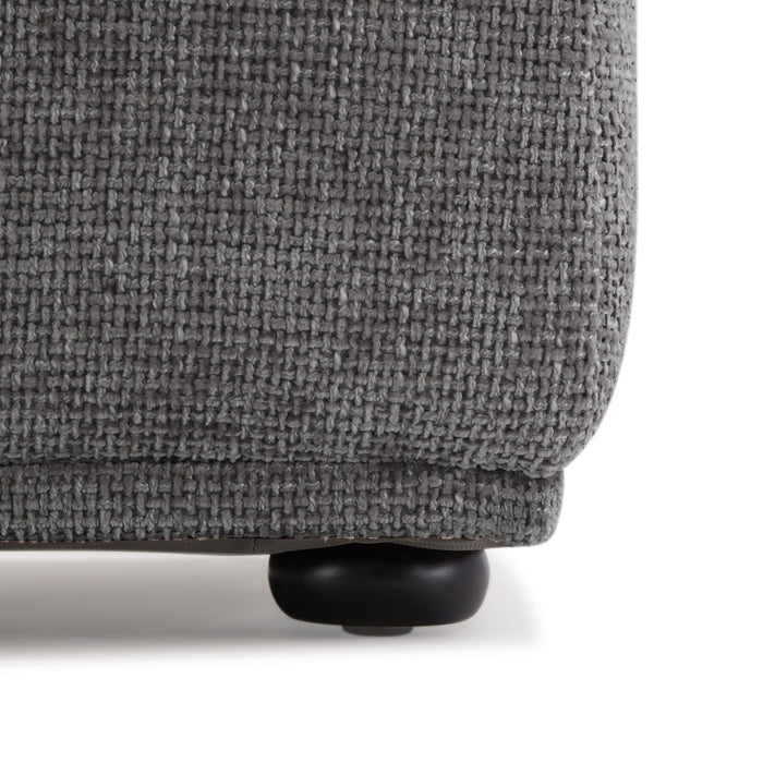 Front facing close up of the leg of a contemporary grey chenille trapezoidal armless chair with an adjustable back on a white background