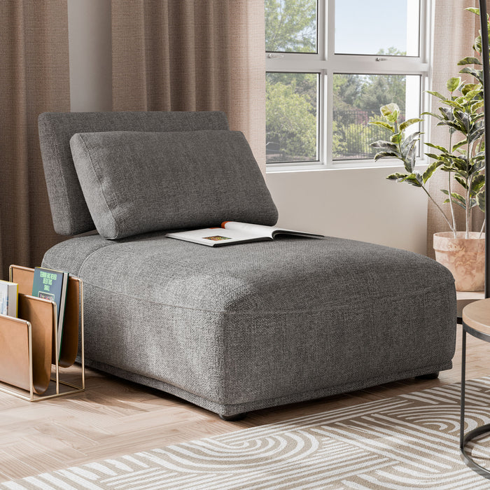 Right facing contemporary grey chenille trapezoidal armless chair with an adjustable back in a room with accessories