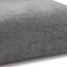 Right facing close up of the seat of a contemporary grey chenille trapezoidal armless chair with an adjustable back on a white background