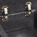 Right facing close up of the hinges of the console top of a transitional dark grey faux leather reclining sectional sofa with a storage console