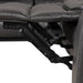 Left facing close up of the leg rest extension mechanism of a transitional dark grey faux leather reclining sectional sofa with a storage console on a white background