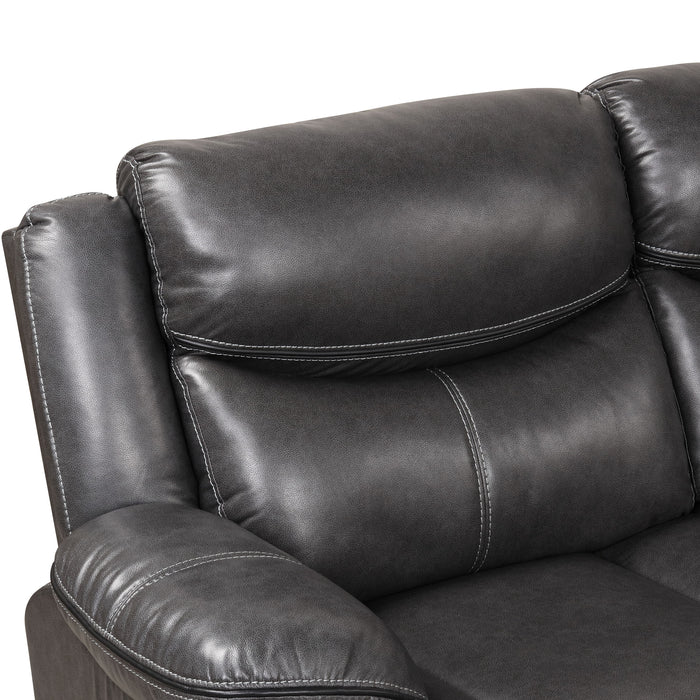 Right facing close up of the backrest and accent stitching of a transitional dark grey faux leather reclining sectional sofa with a storage console