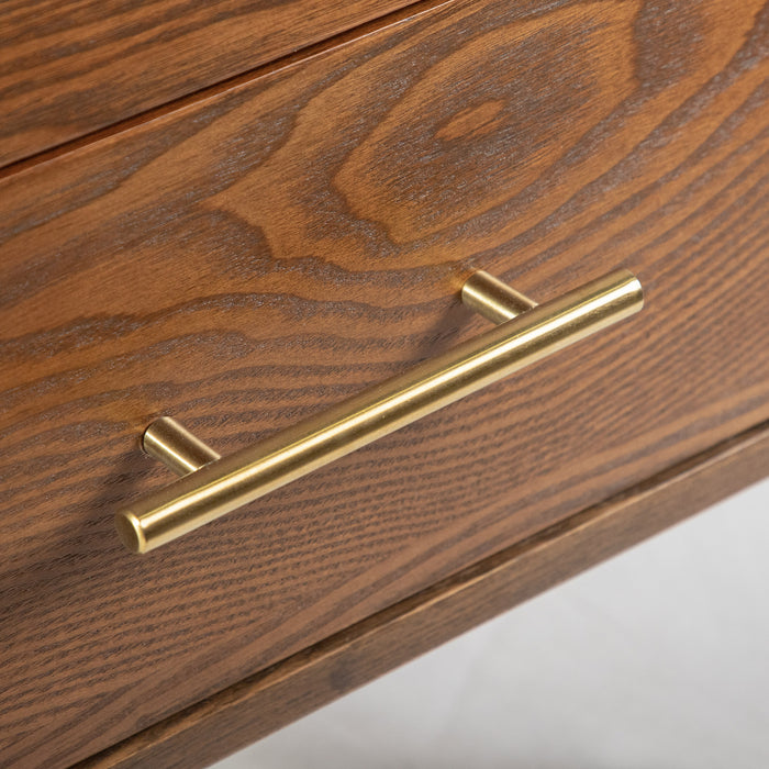 Right facing close up view of a bar pull on a mid-century modern walnut finish five-drawer chest on a white background