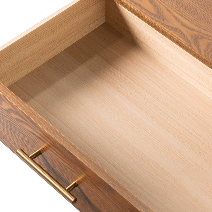 Left facing close up view of an open drawer on a mid-century modern walnut finish five-drawer chest on a white background