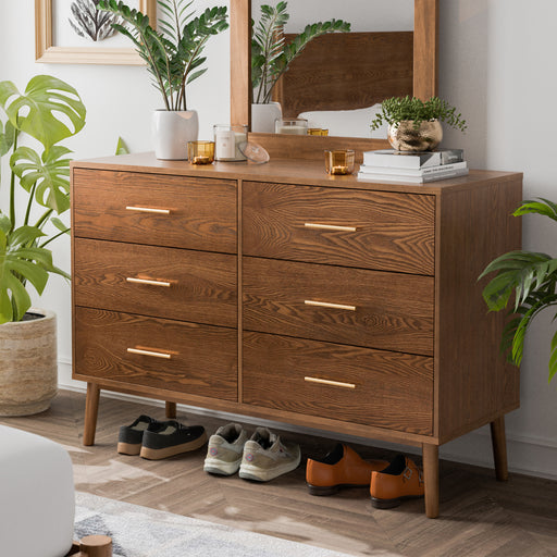 Left facing mid-century modern walnut finish six-drawer dresser in a room with accessories