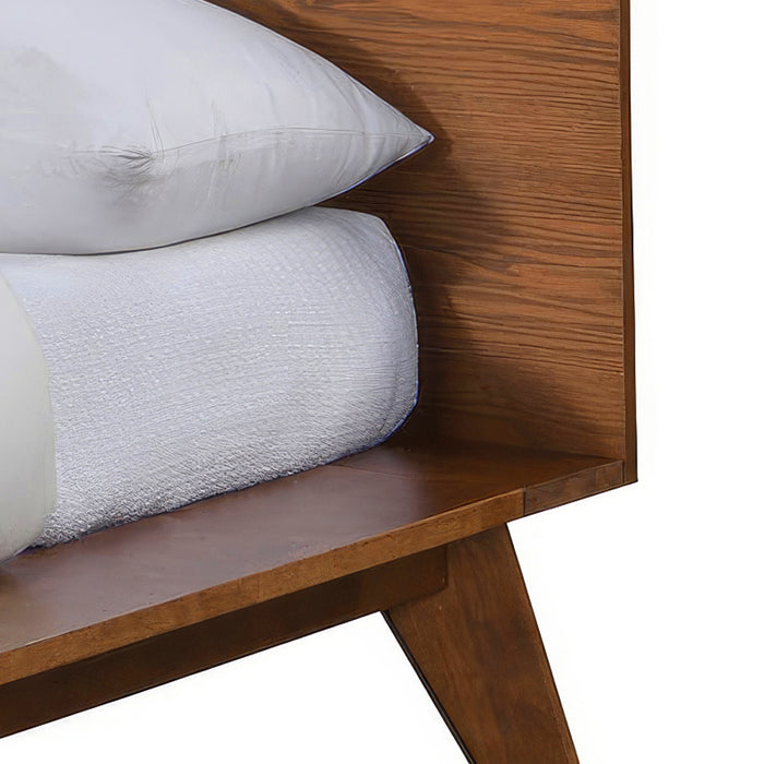 Left facing close up view of the headboard, rail, and leg on a mid-century modern walnut finish rounded corner queen bed on a white background
