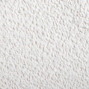 Swatch of the boucle upholstery of a mid-century modern walnut and beige boucle wingback queen bed