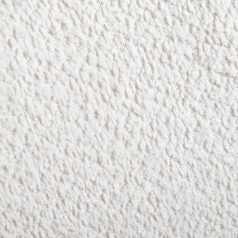 Swatch of the boucle upholstery of a mid-century modern walnut and beige boucle wingback queen bed