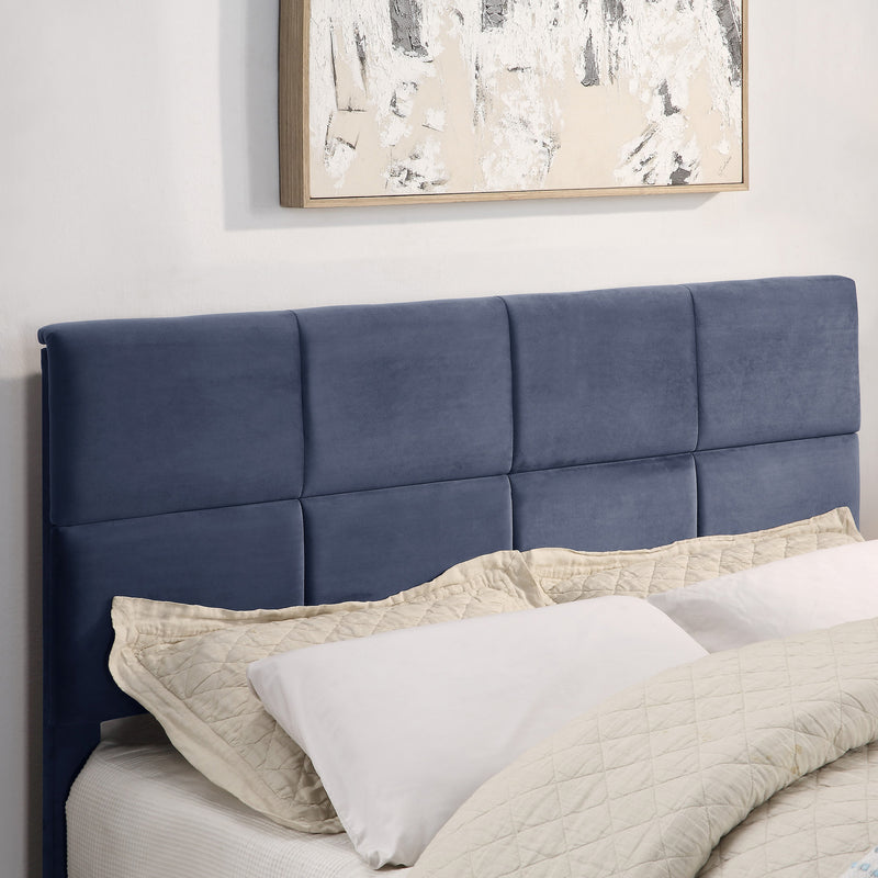 Right facing close up of the headboard on a contemporary grey upholstered full bed with attached storage bench in a room with linens and accessories