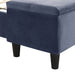 Right facing close up of the storage bench on a contemporary grey upholstered full bed with attached storage bench in a room with linens and accessories