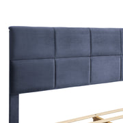 Right facing close up of the headboard on a contemporary grey upholstered full bed with attached storage bench on a white background