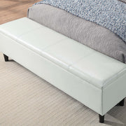Left facing close up of the closed storage bench on a contemporary white upholstered full bed with attached storage bench in a room with linens and accessories