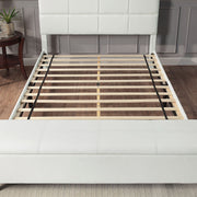Front facing contemporary white upholstered full bed with attached storage bench in a room with accessories
