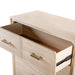Left facing close up of the metal base on a transitional light oak five-drawer chest with the top drawer open, on a white background