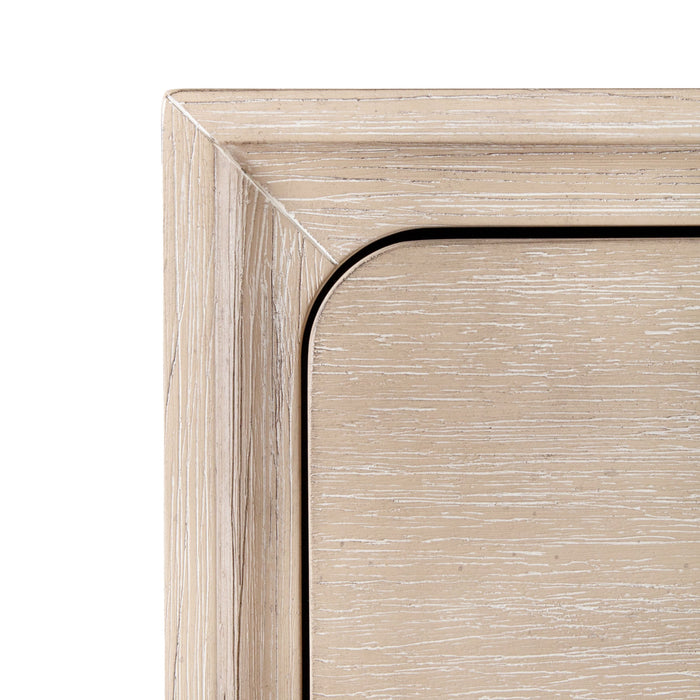 Front facing close up of the rounded drawer front design on a transitional light oak five-drawer chest with a metal base, on a white background