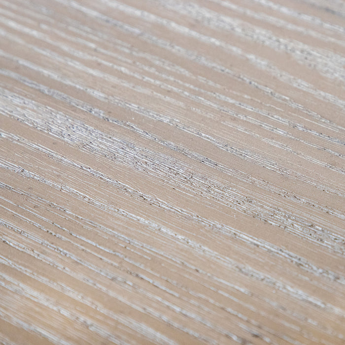 Close up swatch image of the light oak finish on a transitional light oak five-drawer chest with a metal base