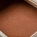 Left facing close up of an open felt-lined drawer on a transitional light oak two-drawer nightstand with a metal base on a white background