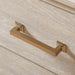 Left facing close up of the bronze bar pull on a transitional light oak two-drawer nightstand with a metal base