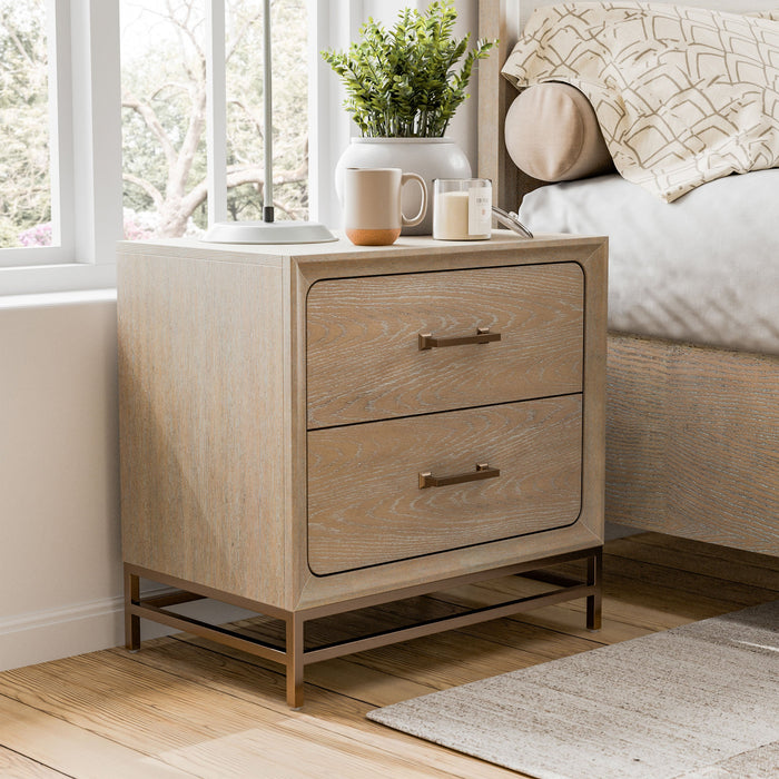 Right facing transitional light oak two-drawer nightstand with a metal base in a room with accessories