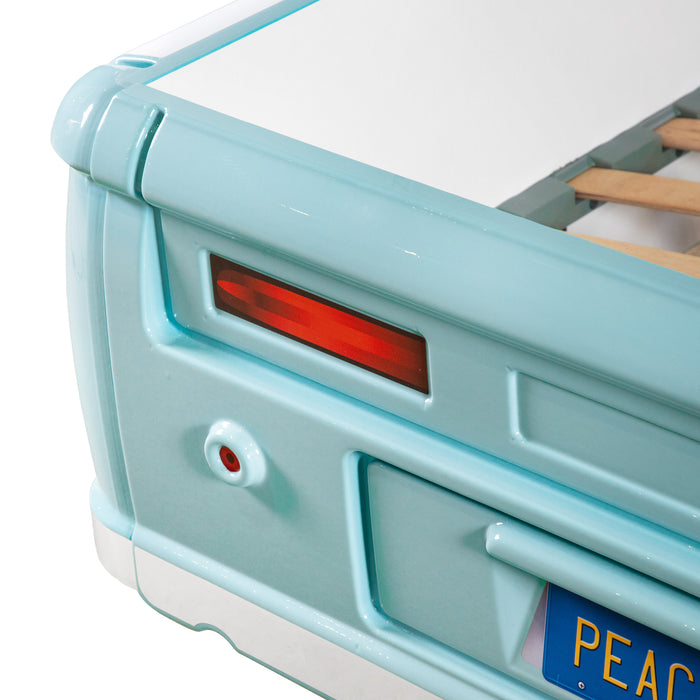 Angled close up of the tail lights on a vintage teal peace bus novelty kid's platform bed