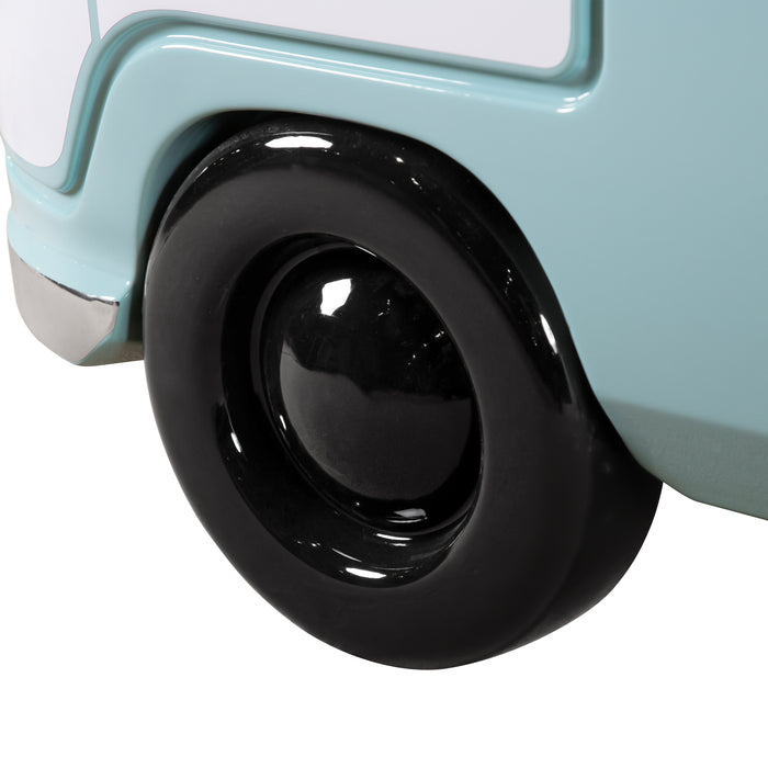 Angled close up of the wheel on a vintage teal peace bus novelty kid's platform bed