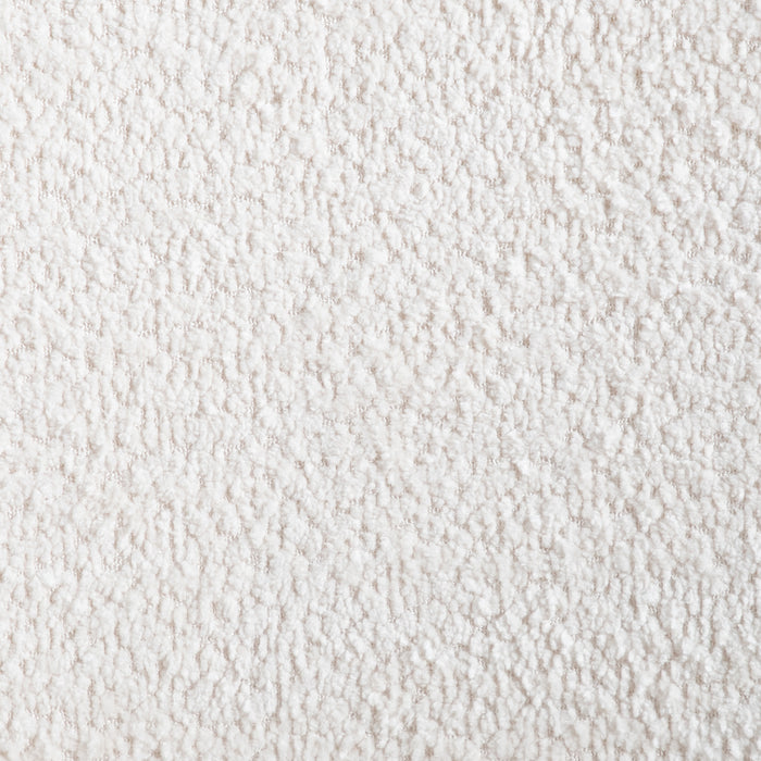Swatch of the ivory boucle upholstery of amid-century modern walnut and ivory boucle accent armchair