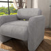 Left facing contemporary gray boucle upholstered accent armchair in a room with accessories