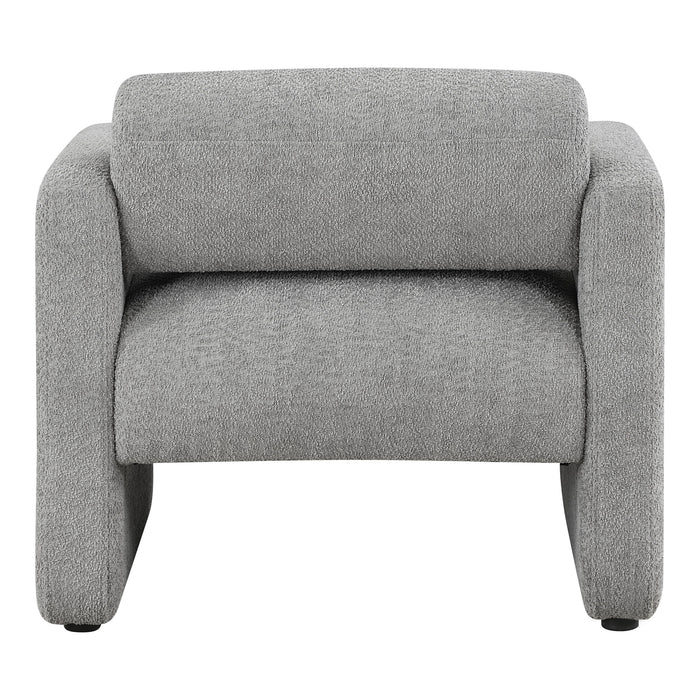 Front facing side view of a contemporary gray boucle upholstered accent armchair on a white background
