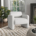 Right facing contemporary white boucle upholstered accent armchair in a room with accessories