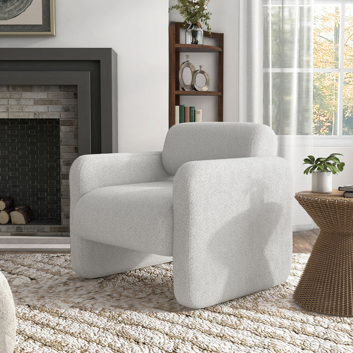 Left facing contemporary white boucle upholstered accent armchair in a room with accessories