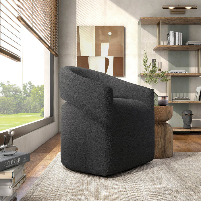 Right facing contemporary charcoal grey boucle 360-degree swivel accent chair in a room with accessories