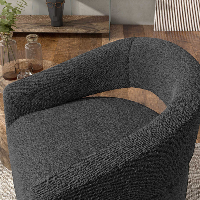 Right facing contemporary charcoal grey boucle 360-degree swivel accent chair on a white background