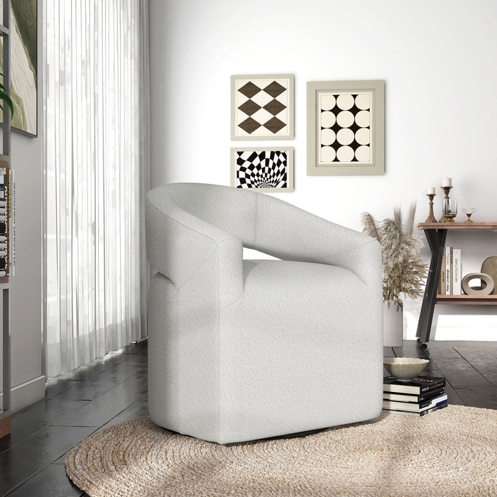 Right facing contemporary white boucle 360-degree swivel accent chair in a room with accessories