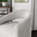 Left facing close up of a contemporary white boucle 360-degree swivel accent chair in a room with accessories