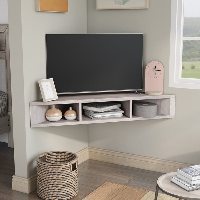 Right facing contemporary white oak floating wall mount media console in a room with accessories