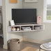 Right facing contemporary white oak floating wall mount media console in a room with accessories
