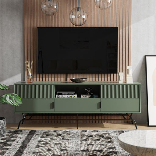 Front facing contemporary sage green and black three-drawer two-door TV stand with fluting in a room with accessories