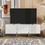 Front facing contemporary white and vintage gold fluted three-door TV stand in a room with accessories