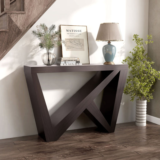 Right facing modern farmhouse espresso slant-design console table in a room with accessories