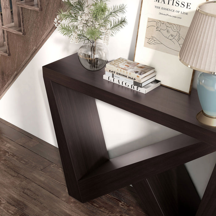 Left facing bird's eye close up view of a modern farmhouse espresso slant-design console table in a room with accessories