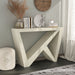 Left facing modern farmhouse cream weave slant-design console table in a room with accessories