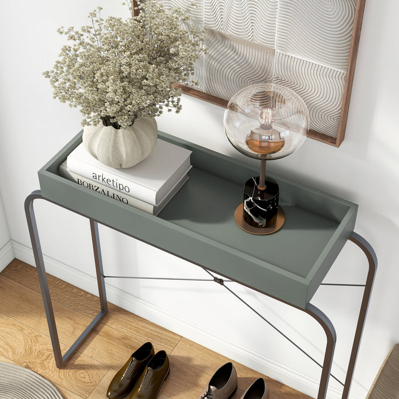 Left facing bird's eye view of a modern sage green and black tray style console table in a room with accessories
