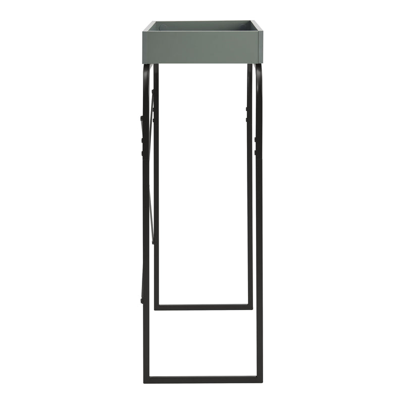 Front facing side view of a modern sage green and black tray style console table on a white background