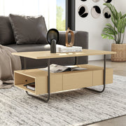 Right facing contemporary light maple and black multi-shelf coffee table with one drawer in a living room with accessories